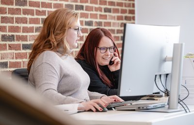 2 staff around screen