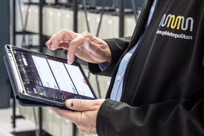 Employee looking at tablet in plant room